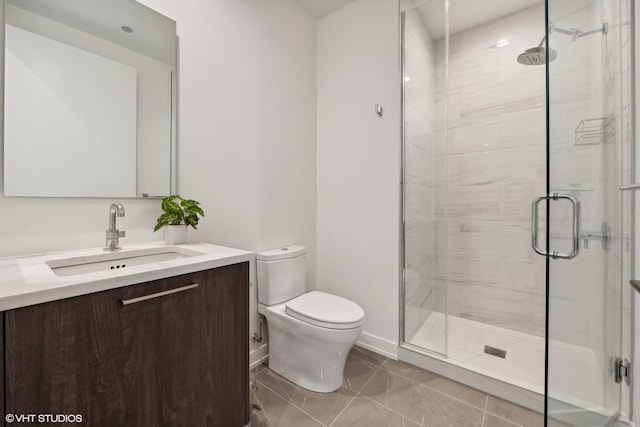 bathroom featuring tile patterned floors, a shower with door, vanity, and toilet