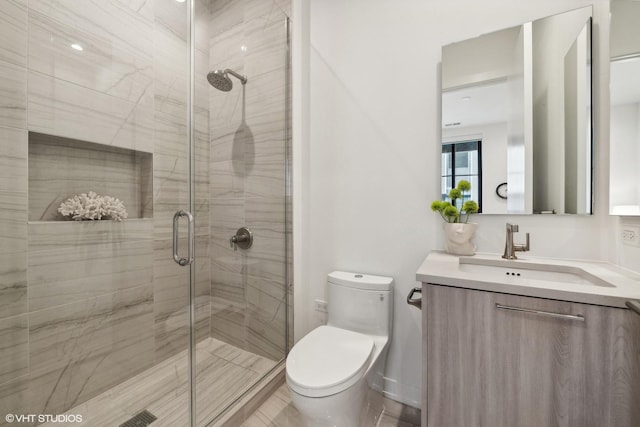 bathroom featuring vanity, toilet, and walk in shower