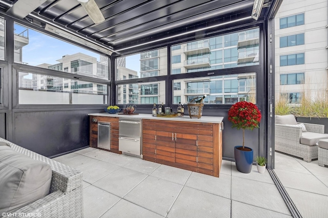 view of patio / terrace featuring ceiling fan and exterior kitchen