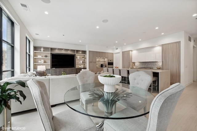 dining space featuring sink and light hardwood / wood-style flooring