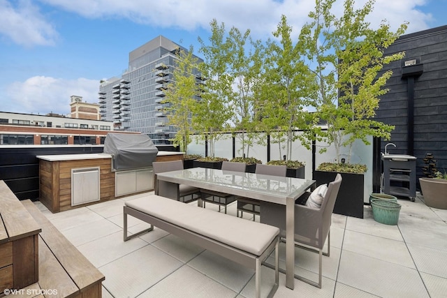 view of patio with grilling area and an outdoor kitchen