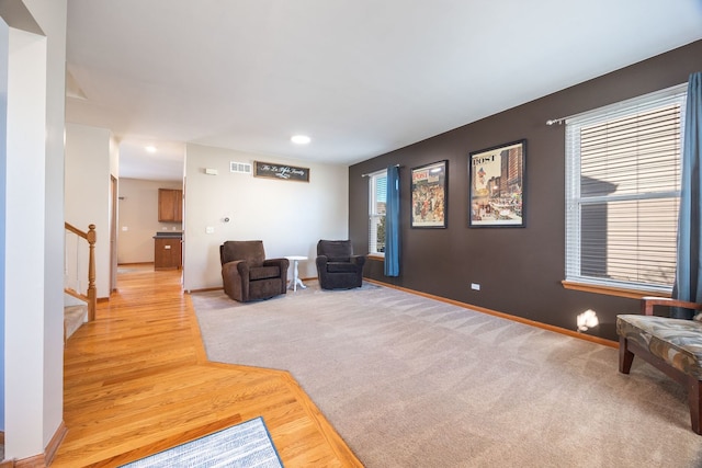 sitting room with light hardwood / wood-style floors and a healthy amount of sunlight