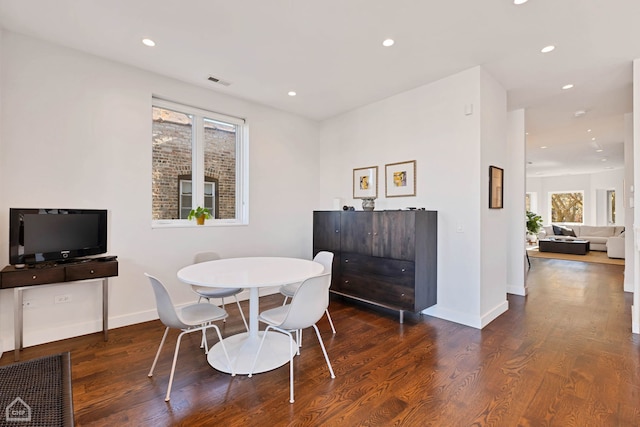 dining space featuring dark wood-type flooring