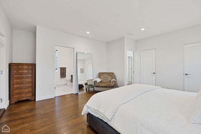 bedroom with ensuite bathroom and dark wood-type flooring