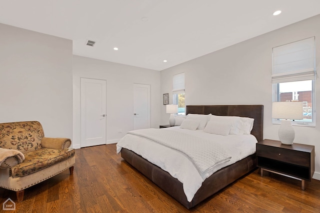 bedroom featuring dark hardwood / wood-style floors and multiple windows