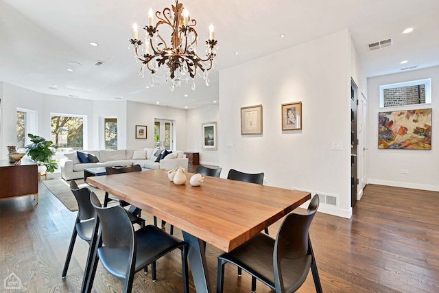 dining space with a chandelier and dark hardwood / wood-style floors