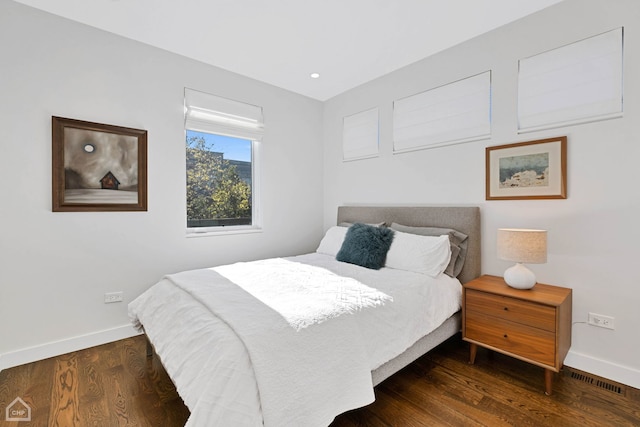 bedroom with dark wood-type flooring