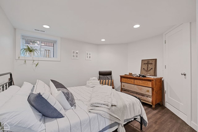 bedroom with dark hardwood / wood-style floors