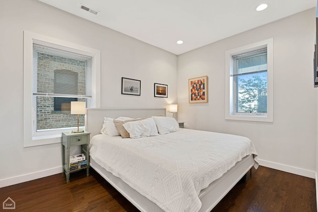 bedroom with dark hardwood / wood-style flooring