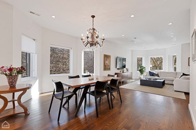 dining area with a chandelier and dark hardwood / wood-style floors