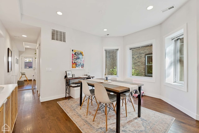 dining space with dark hardwood / wood-style flooring