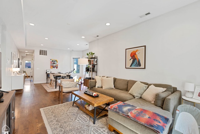 living room with dark hardwood / wood-style flooring