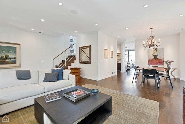 living room with dark hardwood / wood-style floors and a chandelier