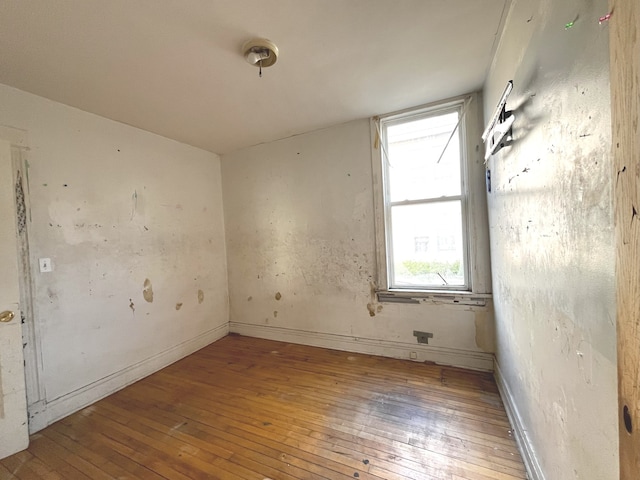 unfurnished room with hardwood / wood-style floors