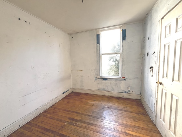 empty room with hardwood / wood-style flooring