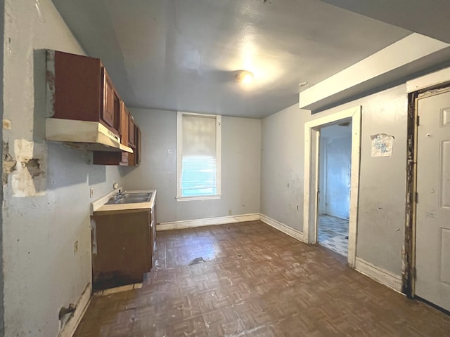 kitchen featuring dark parquet flooring