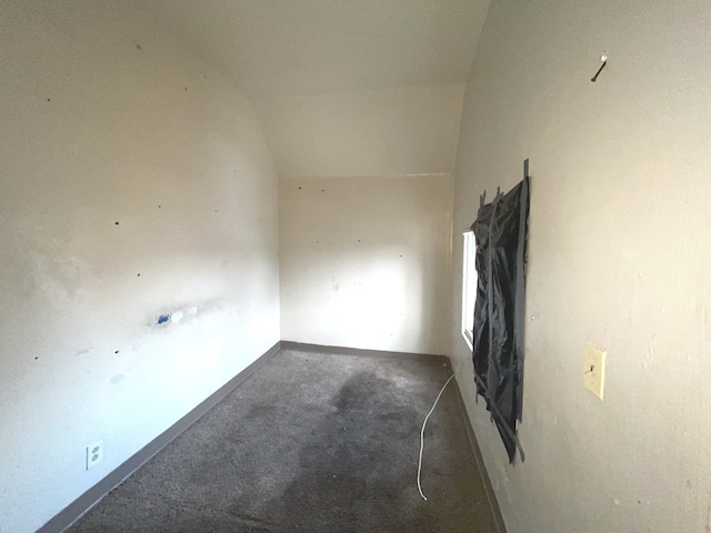 empty room featuring vaulted ceiling