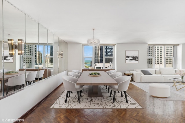 dining area with an inviting chandelier and dark parquet floors