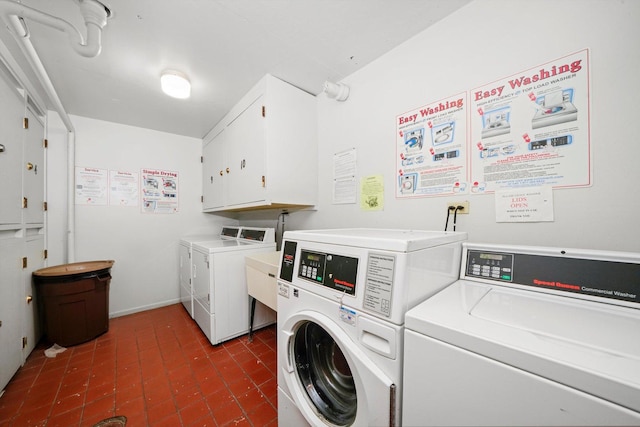 washroom with cabinets and separate washer and dryer