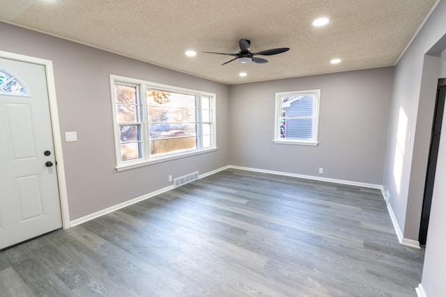 foyer featuring ceiling fan, dark hardwood / wood-style floors, and a textured ceiling