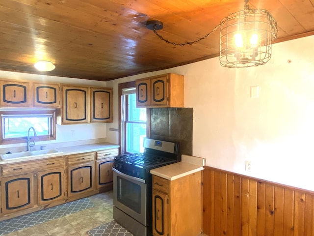 kitchen with sink, hanging light fixtures, stainless steel range oven, wood walls, and wood ceiling