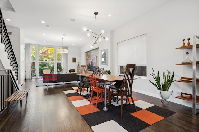 dining area with dark hardwood / wood-style flooring, an inviting chandelier, and expansive windows