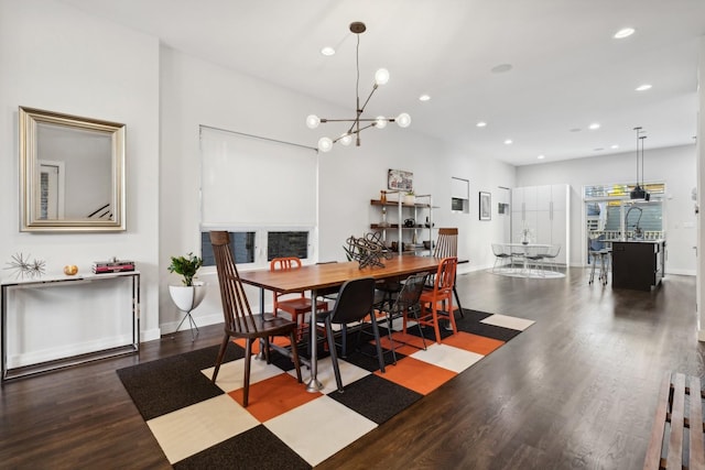 dining area featuring hardwood / wood-style flooring and a notable chandelier