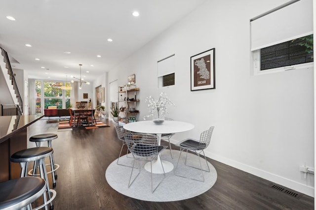 dining space featuring dark wood-type flooring