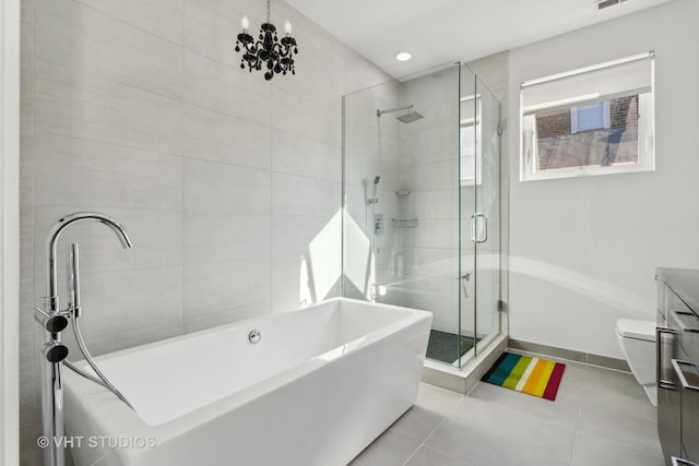 full bathroom featuring tile patterned flooring, toilet, vanity, independent shower and bath, and an inviting chandelier