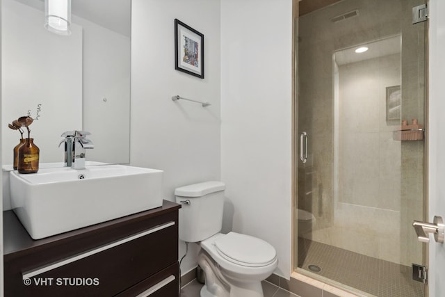 bathroom with toilet, an enclosed shower, vanity, and tile patterned floors