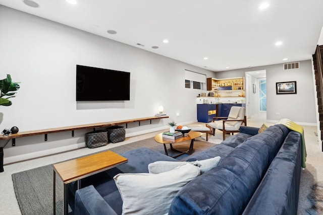 carpeted living room featuring bar