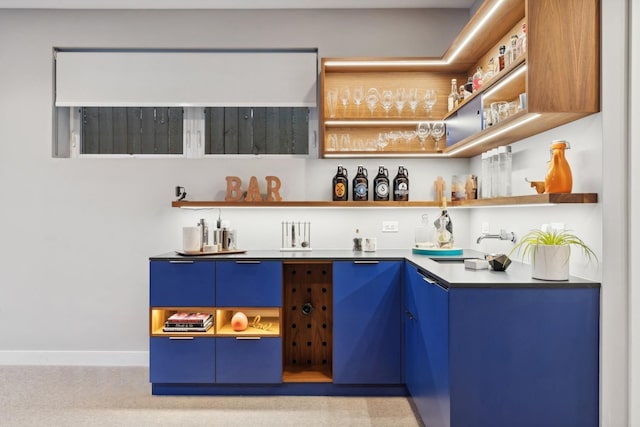 bar featuring sink and blue cabinetry