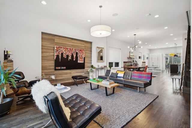 living room featuring dark wood-type flooring and an inviting chandelier