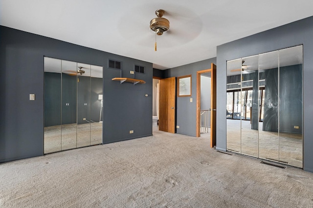 unfurnished bedroom with carpet flooring, visible vents, and a ceiling fan