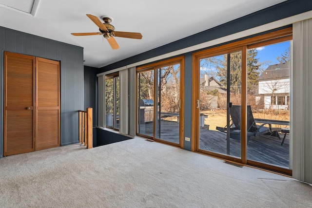 interior space with access to outside, carpet floors, a closet, and visible vents