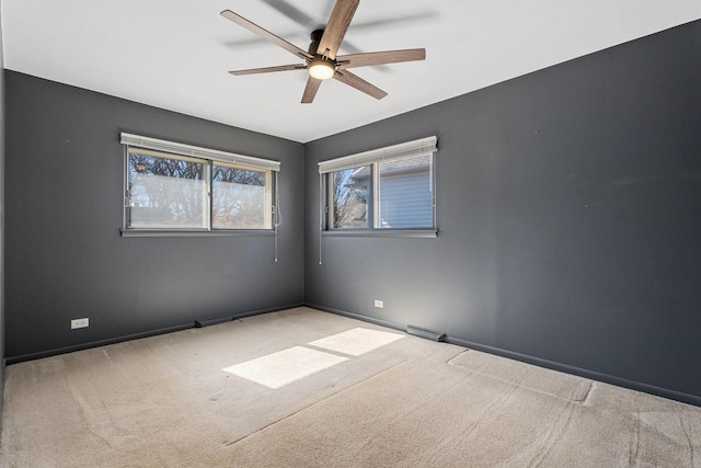 unfurnished room featuring carpet floors, ceiling fan, and baseboards