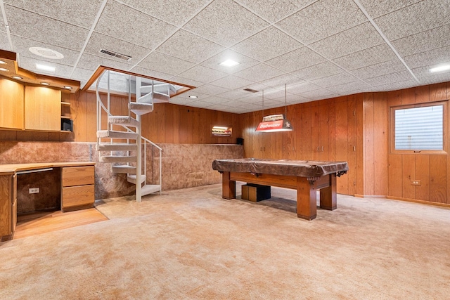 game room featuring wooden walls, a paneled ceiling, light carpet, and visible vents