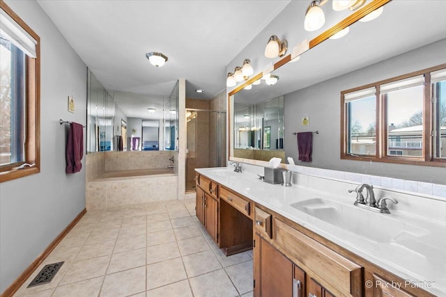 bathroom featuring shower with separate bathtub, vanity, and tile patterned floors