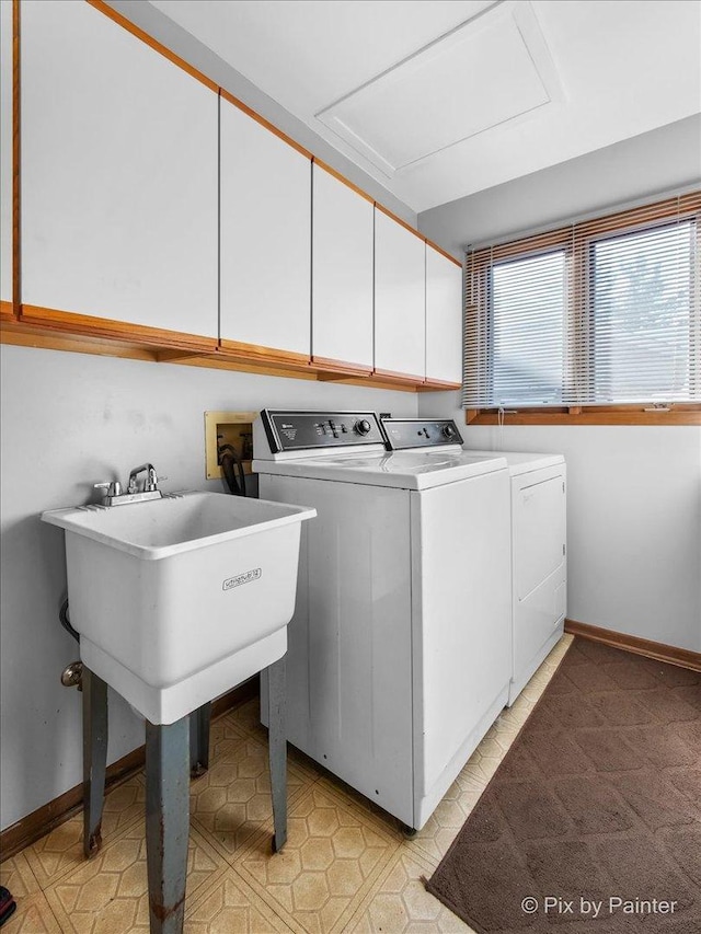 laundry room with cabinets and washer and clothes dryer