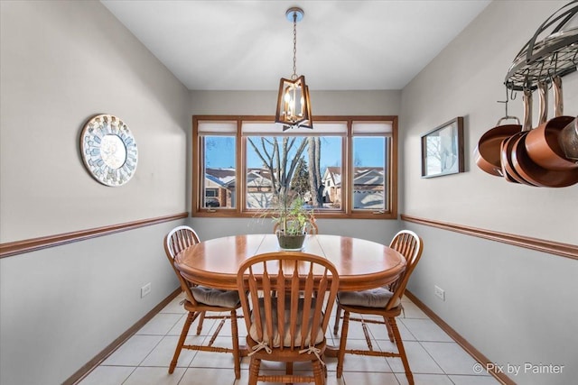 dining area with light tile patterned flooring and a notable chandelier