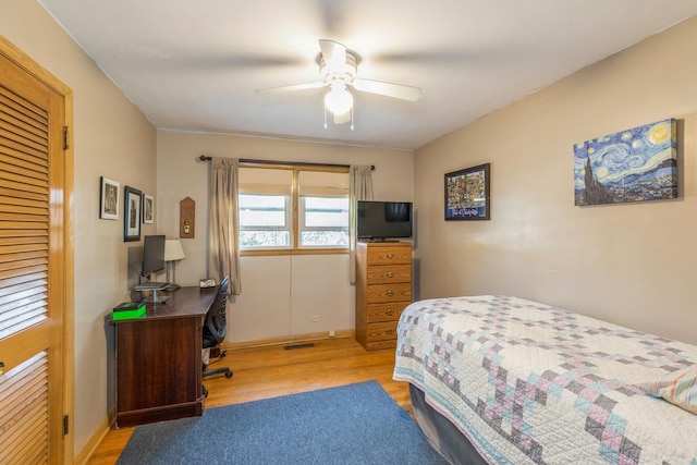 bedroom with light hardwood / wood-style floors and ceiling fan