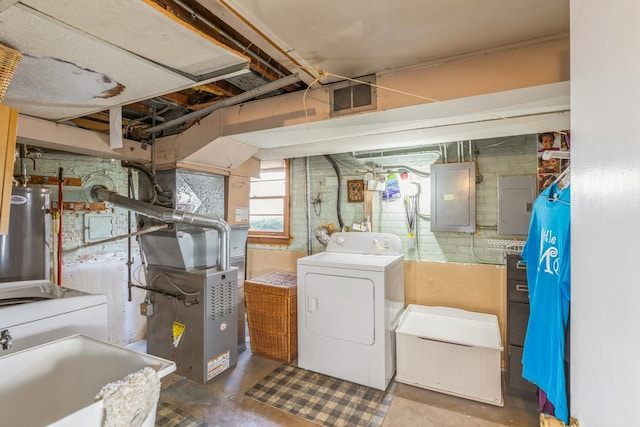 basement featuring electric panel, gas water heater, sink, washer / clothes dryer, and heating unit