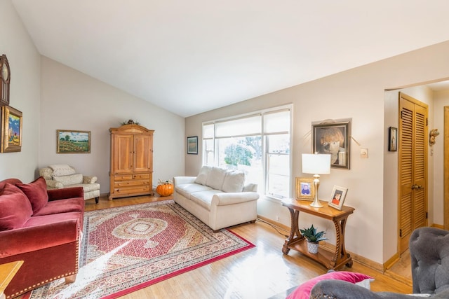 living room with lofted ceiling and light wood-type flooring