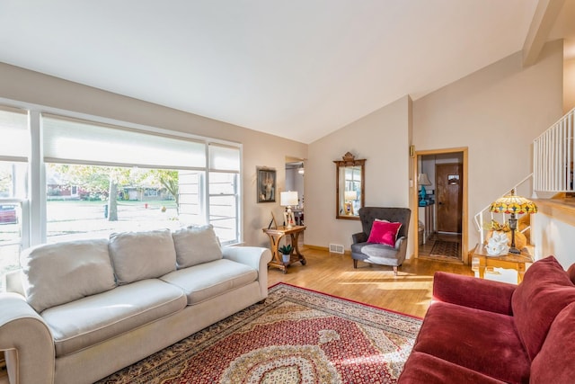 living room with wood-type flooring and vaulted ceiling