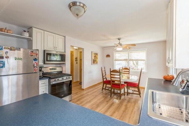 kitchen featuring white cabinets, appliances with stainless steel finishes, ceiling fan, and sink