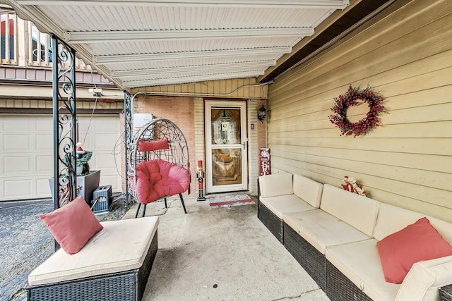 view of patio with an outdoor living space and a garage