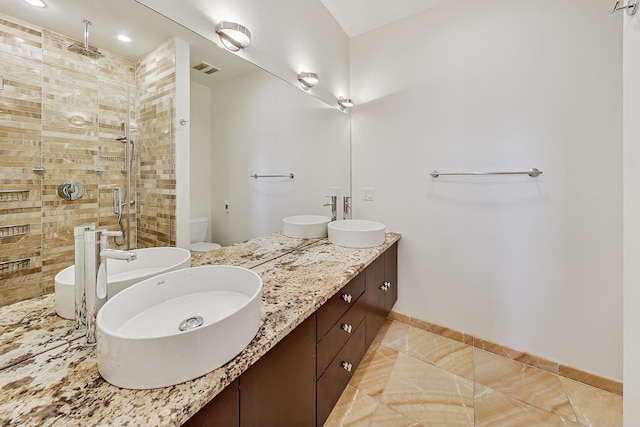 bathroom with vanity, toilet, and a shower with shower door