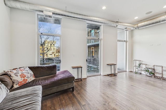 living room featuring hardwood / wood-style floors and a high ceiling