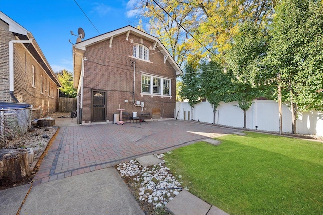 rear view of house featuring a lawn and cooling unit