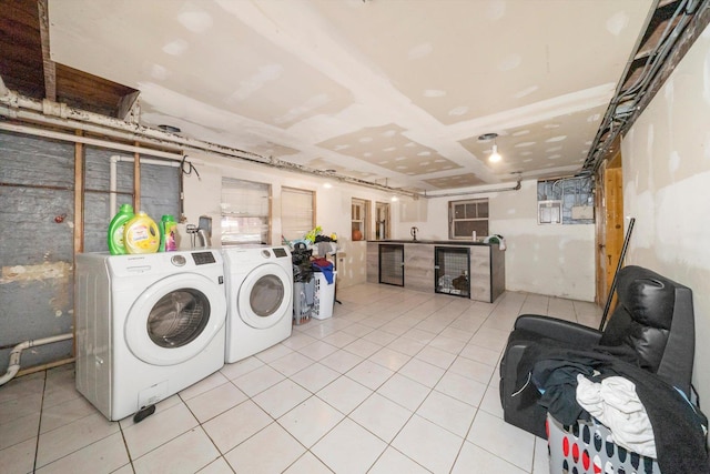 laundry room with washer and dryer, sink, and light tile patterned flooring